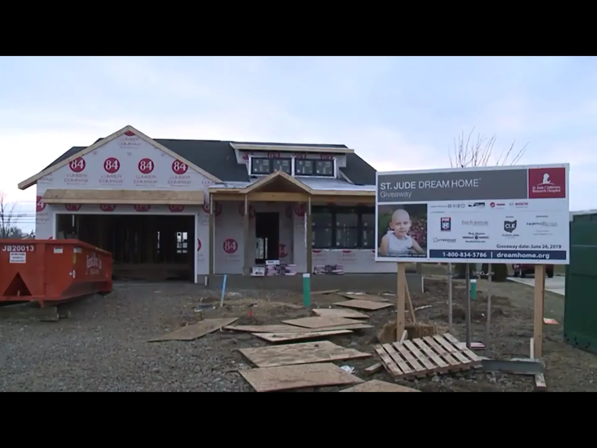 St. Jude Dream Home under construction with a JunkBox roll-off dumpster in the driveway